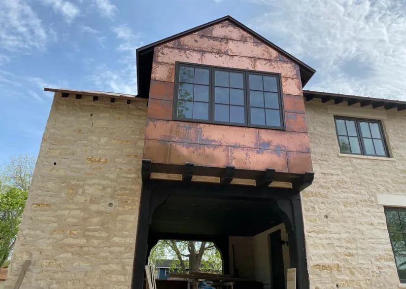 Copper metal panel facade on a stone building for Skylight Installation in Escondido